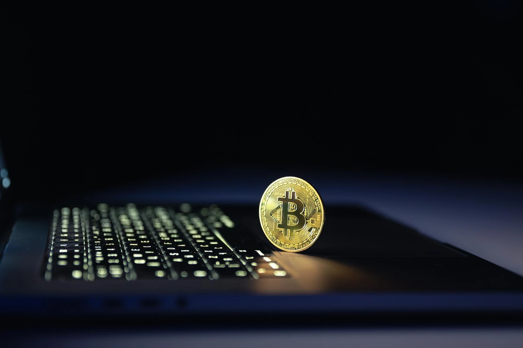 Bitcoin-mynt ved en bærbar datamaskin